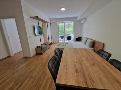 a large room with a large wooden table and chairs at Luxury Apartment IVA III in Skopje