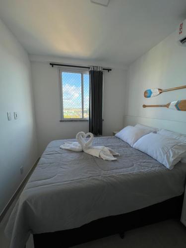 a bedroom with a bed with a towel on it at Vista mar no ultimo andar! in Ilhéus