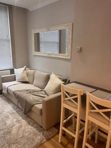a living room with a couch and two chairs at Central private 1 bed flat in Reading