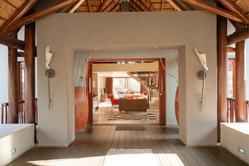 a hallway of a house with a living room at Zebula Lodge 118 in Mabula