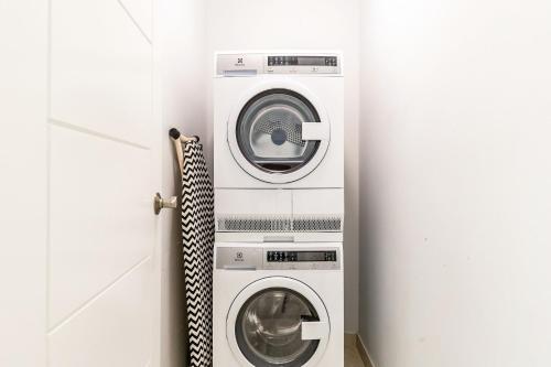 two washing machines are in a white room at NEW Tropical Waterfront Cooper Jack Bay Villas in Five Cays Settlement
