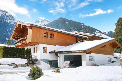 a house with a car parked in front of it in the snow at House in Krimml near Waterfalls & Hiking Trails in Krimml