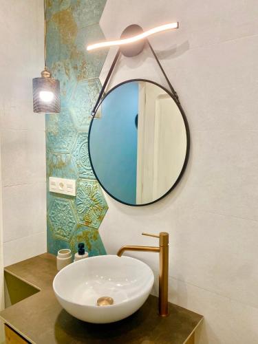 a bathroom with a white sink and a mirror at A Michelena de Pedra in Pontevedra