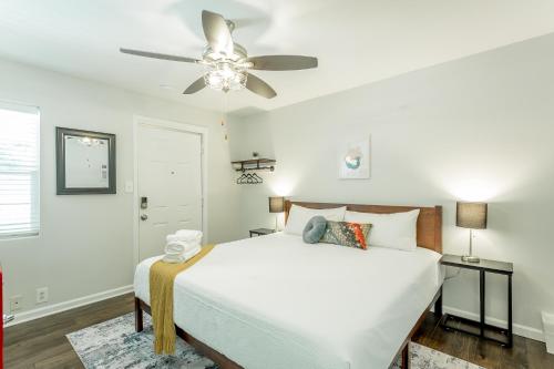 a bedroom with a white bed and a ceiling fan at 14 The Nelson Room - A PMI Scenic City Vacation Rental in Chattanooga