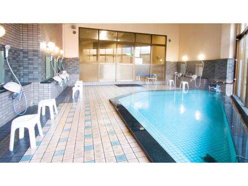 a large swimming pool in a building with at Ashinomaki Prince Hotel - Vacation STAY 55298v in Aizuwakamatsu