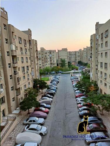 a row of cars parked in a parking lot at Paradise Gates Madinaty B6 -H- in Madinaty