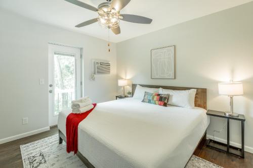 a white bedroom with a large bed and a ceiling fan at 11 The Charlotte Room - A PMI Scenic City Vacation Rental in Chattanooga
