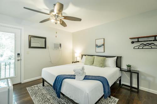 a bedroom with a white bed and a ceiling fan at 13 The Eero Room - A PMI Scenic City Vacation Rental in Chattanooga