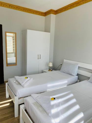 two white beds in a room with a mirror at Stylish Hotel Old City in Istanbul