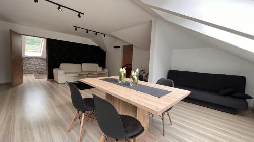 ソリナにあるDom - Apartamenty Prestige - opcja jacuzzi i saunaのリビングルーム(木製テーブル、椅子付)