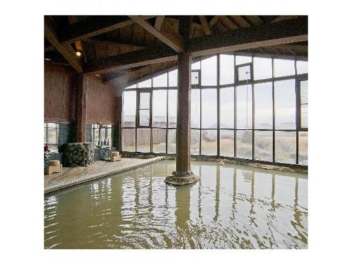 a pool of water in a building with a large window at Resonate Club Shape - Vacation STAY 60134v in Taketa