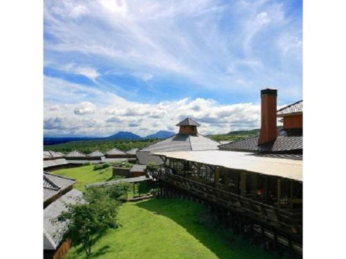arial view of a building with a grassy yard at Resonate Club Shape - Vacation STAY 60135v in Taketa