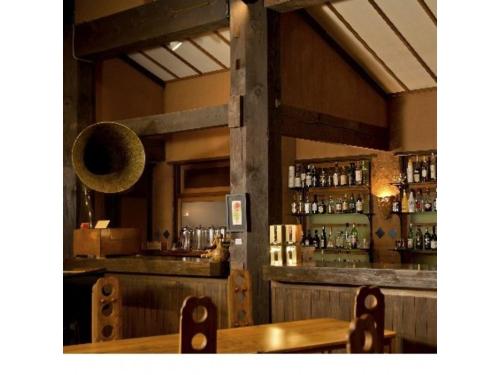a restaurant with a wooden table and a bar at Resonate Club Shape - Vacation STAY 60135v in Taketa