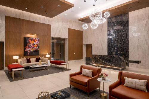 a lobby of a hotel with chairs and a fireplace at Level Los Angeles - Downtown Flower in Los Angeles
