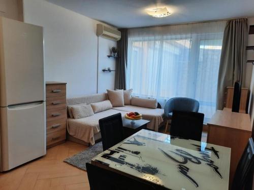 a living room with a couch and a table at Cosy Breeze Apartment in Varna City