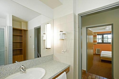 a bathroom with a sink and a mirror at Apartments Sonnenresort Maltschacher See, Feldkirchen in Feldkirchen in Kärnten