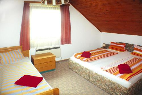 a bedroom with two beds and a window at Apartment in St Kanzian 800 m from the lake in Srejach