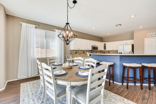 a dining room and kitchen with a table and chairs at Sunny Arizona Getaway with Heated Pool and Patio! in Surprise