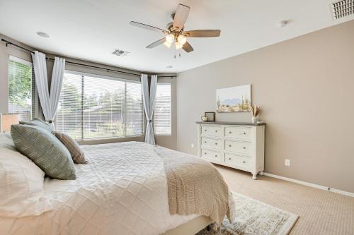 a bedroom with a bed and a ceiling fan at Sunny Arizona Getaway with Heated Pool and Patio! in Surprise
