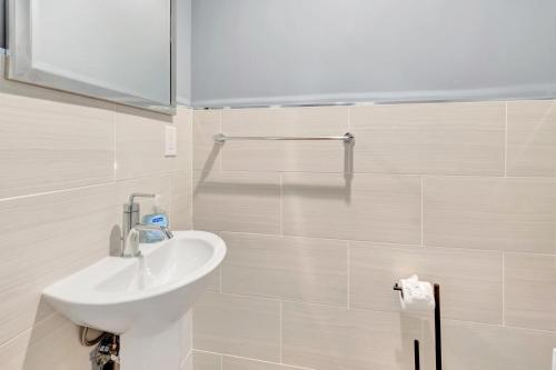 a bathroom with a sink and a mirror at Idyllic Boca Pool Home: 4/2.5 + Study-FAU & Mizner in Boca Raton