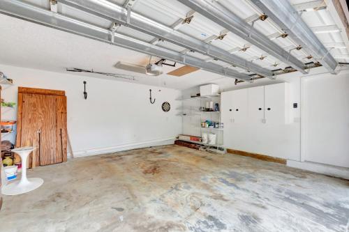 an empty room with white walls and concrete floors at Idyllic Boca Pool Home: 4/2.5 + Study-FAU & Mizner in Boca Raton