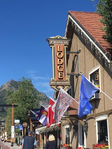 a sign for a hotel on a street with flags at Frisco Lodge in Frisco