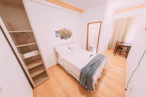 a small bedroom with a bed and a mirror at POUSADA ELMIRA´S BELA VISTA in Ouro Branco