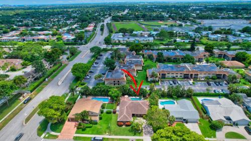an aerial view of a suburb with a house with a red arrow at Idyllic Boca Pool Home: 4/2.5 + Study-FAU & Mizner in Boca Raton