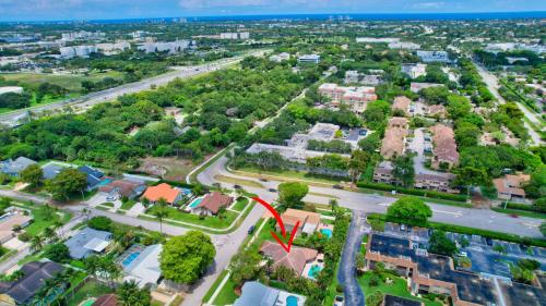 an aerial view of a suburb with a red arrow at Idyllic Boca Pool Home: 4/2.5 + Study-FAU & Mizner in Boca Raton
