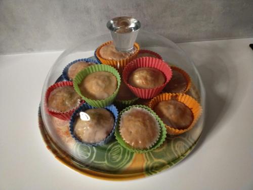 a plate of cupcakes on a glass plate on a table at LA TANA DELLA VOLPETTA - Bed & Breakfast in Stella