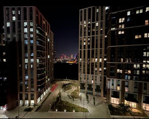 a view of two tall buildings at night at 2 bed apartment close to station with parking in London