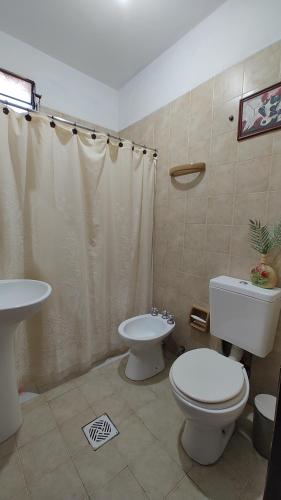 a bathroom with a toilet and a sink at EcoNina in Salta