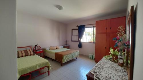 a bedroom with two beds and a window at EcoNina in Salta