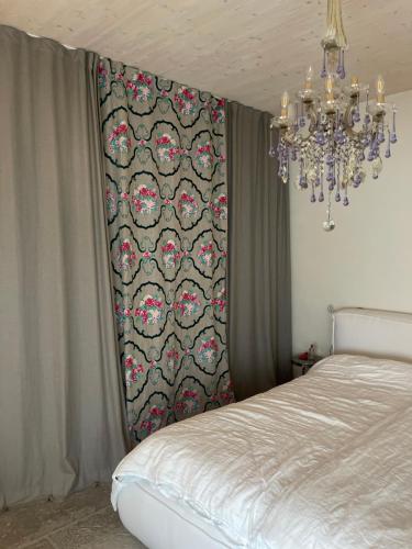 a chandelier is hanging above a bed in a bedroom at Sunhand home in Eibiswald