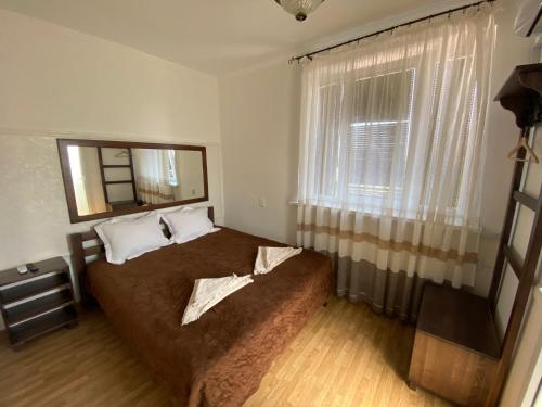 卡緬涅茨波多利斯基的住宿－Family ЛюКс，一间卧室设有一张大床和一个窗户。