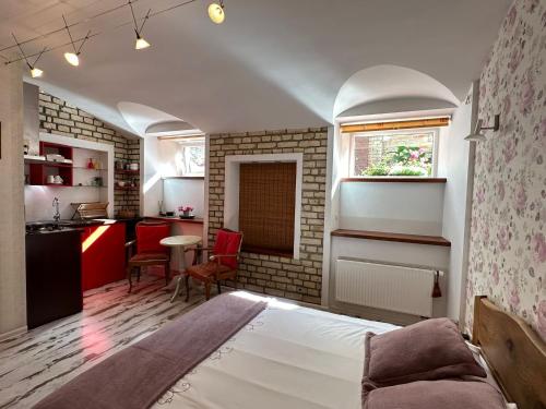 a small room with a bed and a kitchen at Old Town cosy one bedroom apartments with fireplace in Vilnius