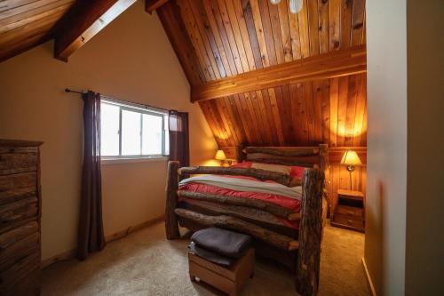 a bedroom with a bed with a wooden ceiling at Leavenworth Mountain View Cabin w/ Space to Hike in Leavenworth