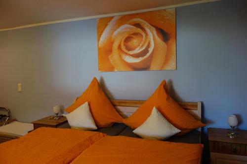 a bedroom with two beds with orange and white pillows at Zehnthof in Geldersheim
