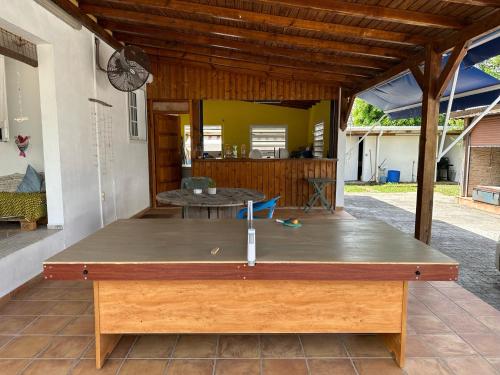 a ping pong table on the patio of a house at Guadeloupe Guesthouse in Port-Louis