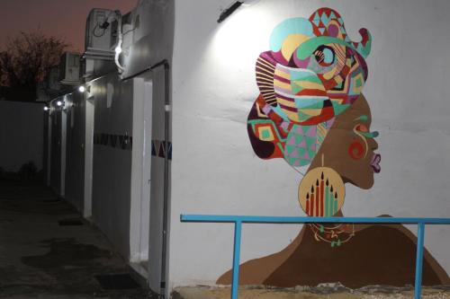 a mural of a woman on the side of a building at Nile View Guest House in Aswan