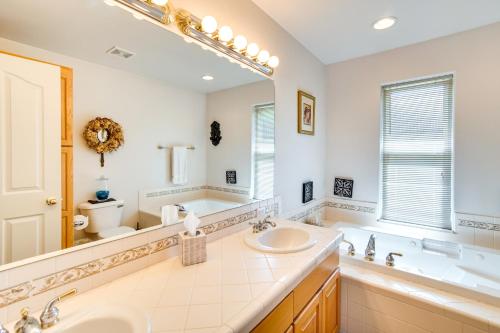 a bathroom with two sinks and a large mirror at Central Washington Home about 6 Mi to Downtown Yakima in Yakima