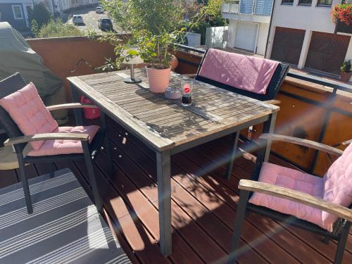 a wooden table and two chairs on a balcony at Muggel Apartments in Alpirsbach