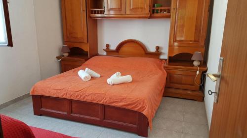 a bedroom with a bed with two towels on it at Apartments Jerko in Vrboska