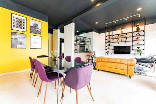 Un comedor con una mesa y sillas moradas. en NEW Perfect Location 24 Hours Security Free Parking, en Ciudad de México