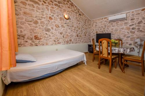 a bedroom with a bed and a table and chairs at House Neda in Ražanj