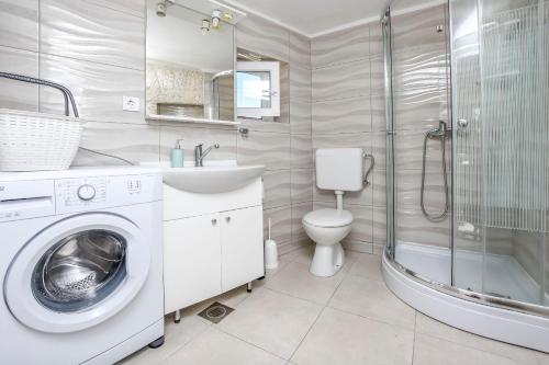 a bathroom with a washing machine and a shower at House Neda in Ražanj