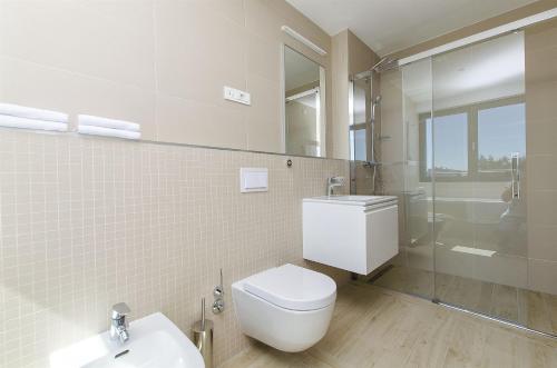 a bathroom with a toilet and a sink and a shower at Villa Ivan in Omiš