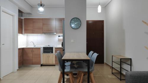 a kitchen and dining room with a table and chairs at Rock & Roll 1 - Modern apartment in Trikala in Tríkala