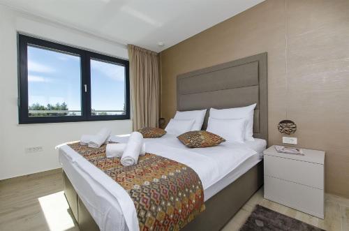 a bedroom with a large bed with white sheets and pillows at Villa Ivan in Omiš