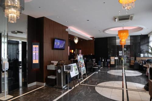 a lobby of a hotel with chandeliers at APA Hotel Toyama-Ekimae Minami in Toyama